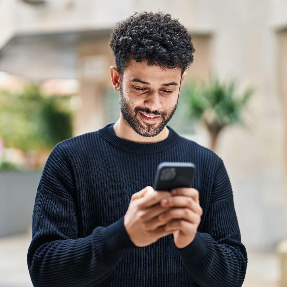 Adult Man watching videos on cell phone
